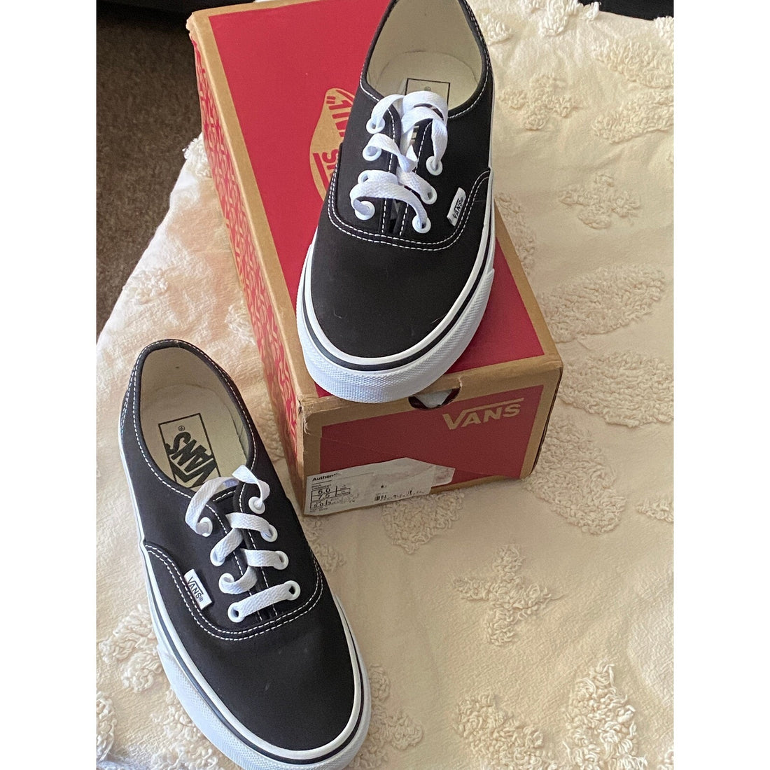 Black sneaker with white laces on a white background