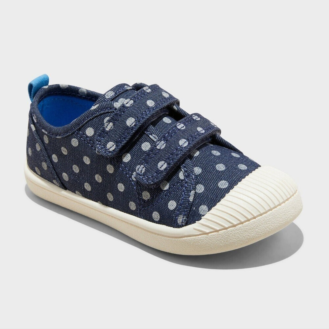 Navy polka dot sneaker with white sole on a light gray background