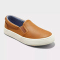 Brown slip-on shoe with white sole on a light gray background