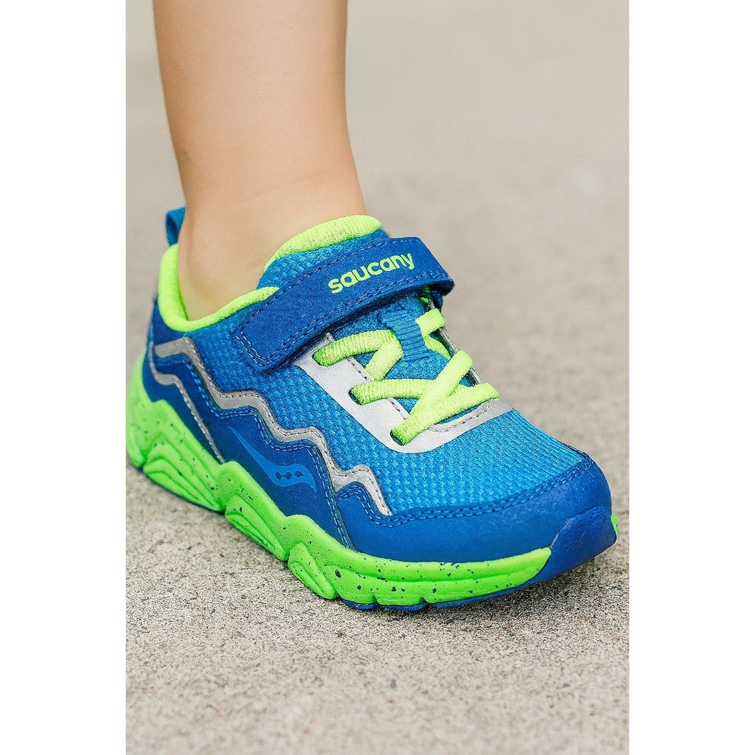 Blue and green running shoe with 'Saucony' branding on a neutral background